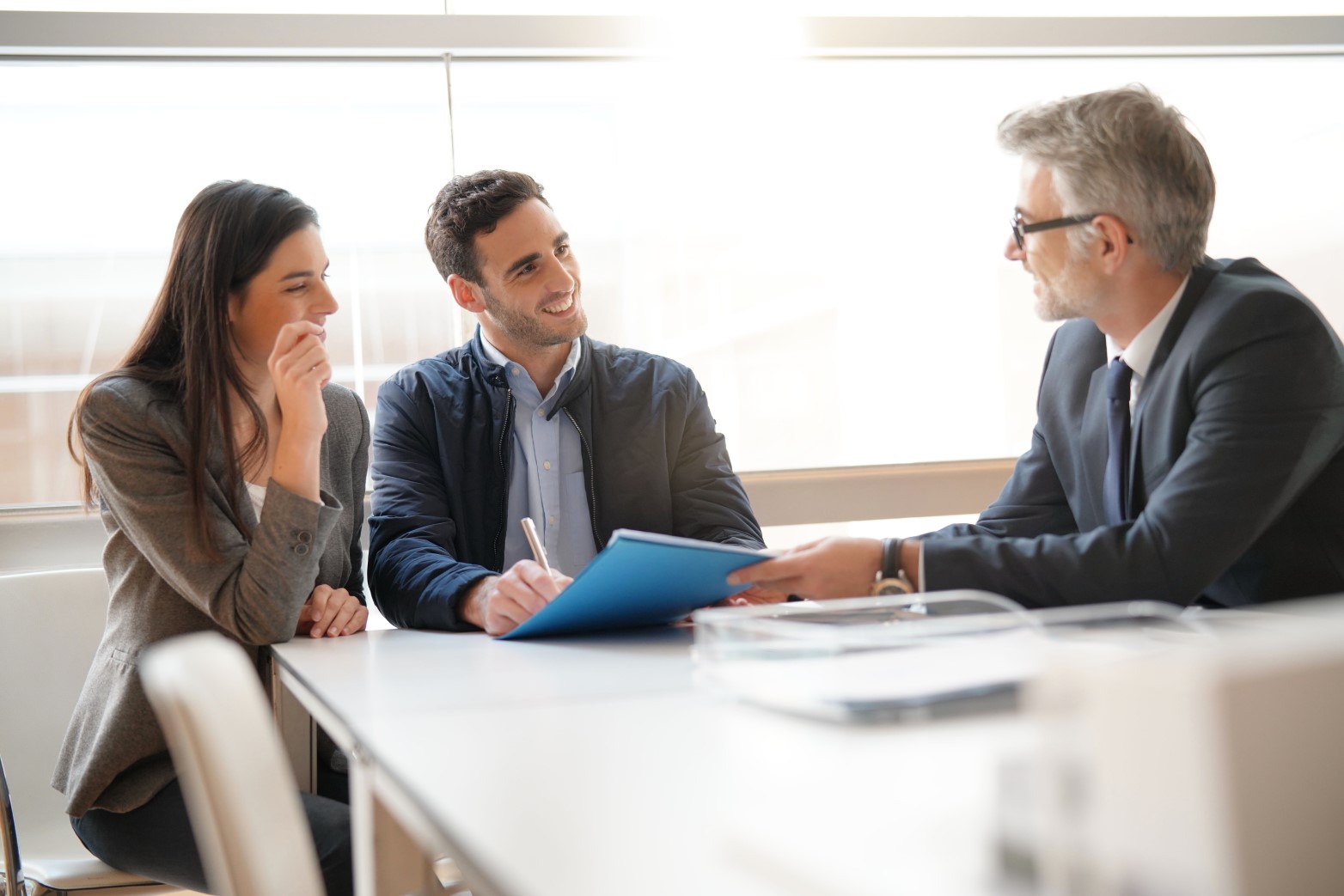 Young couple meeting financial advisor for home investment